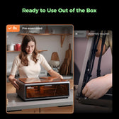 Woman setting a pre-assembled Falcon A1 on a kitchen counter, beside a view of cable assembly on another machine
